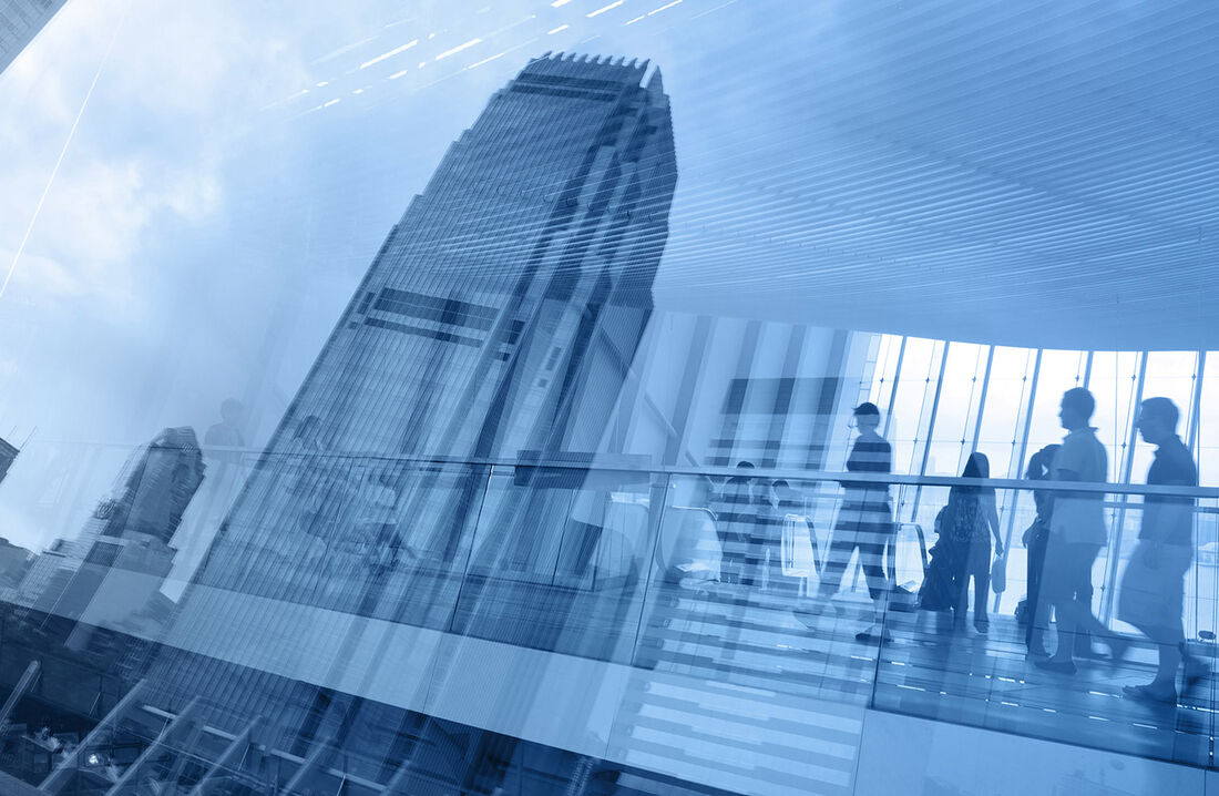 Businesspeople und Hochhäuser in einer Glasfrontspiegelung